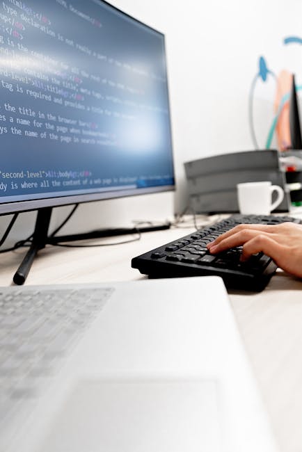 The image displays a close-up view of a computer screen showing lines of code in various colors, including blue, pink, green, and white, against a dark background. The code appears to be part of a Jav